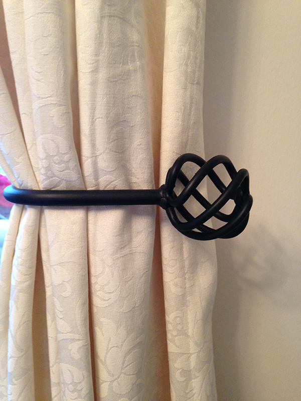 A Pair of Black Hand Made Wrought Iron Ball Cage Tie Backs